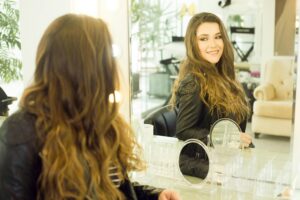 self-confident girl looking in the mirror